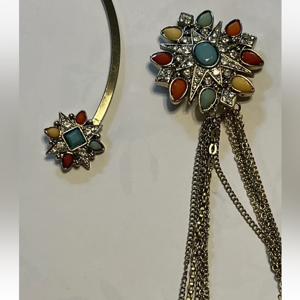 Gold tone collar necklace with attached layered chains and brooch. Pastels